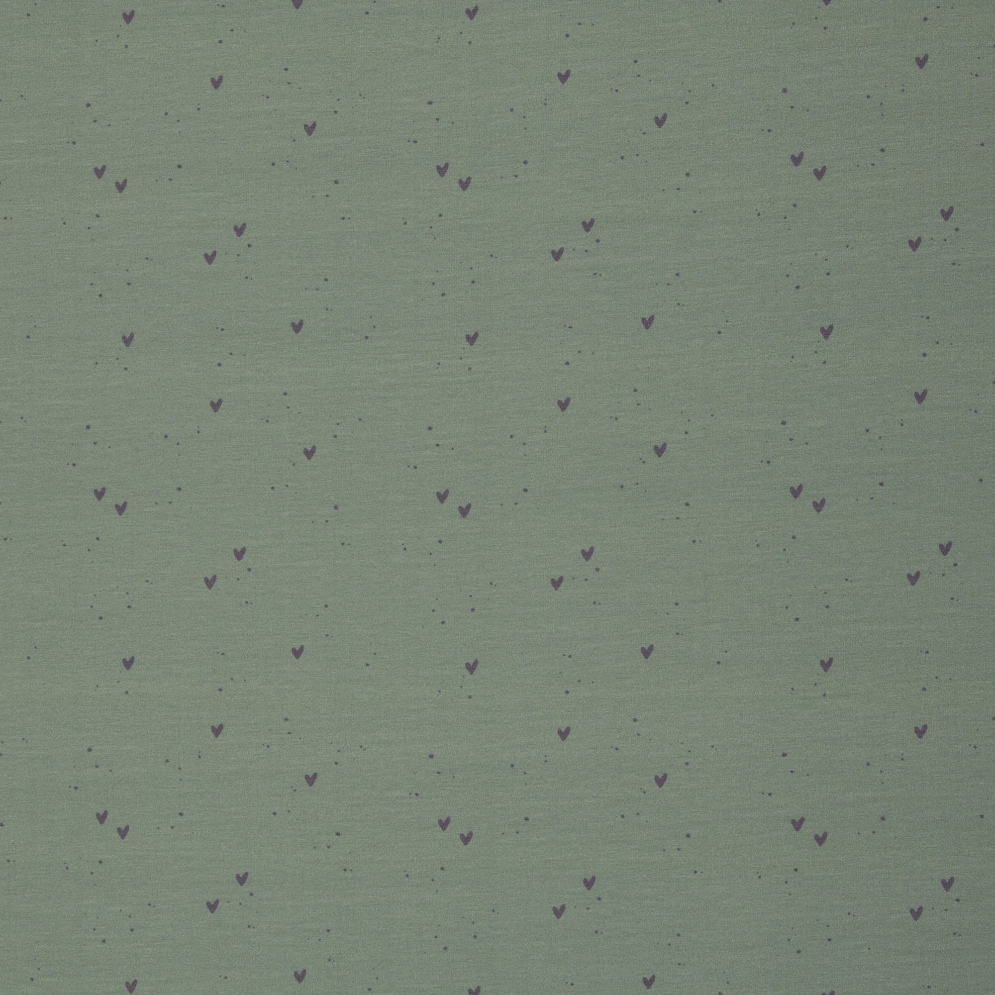 Zu sehen ist ein weicher, elastischer Baumwolljersey-Stoff in Grün mit süßen Herz-Motiven, der durch seine angenehme, glatte Oberfläche ideal für Kleidung, Accessoires und kreative DIY-Projekte geeignet ist.