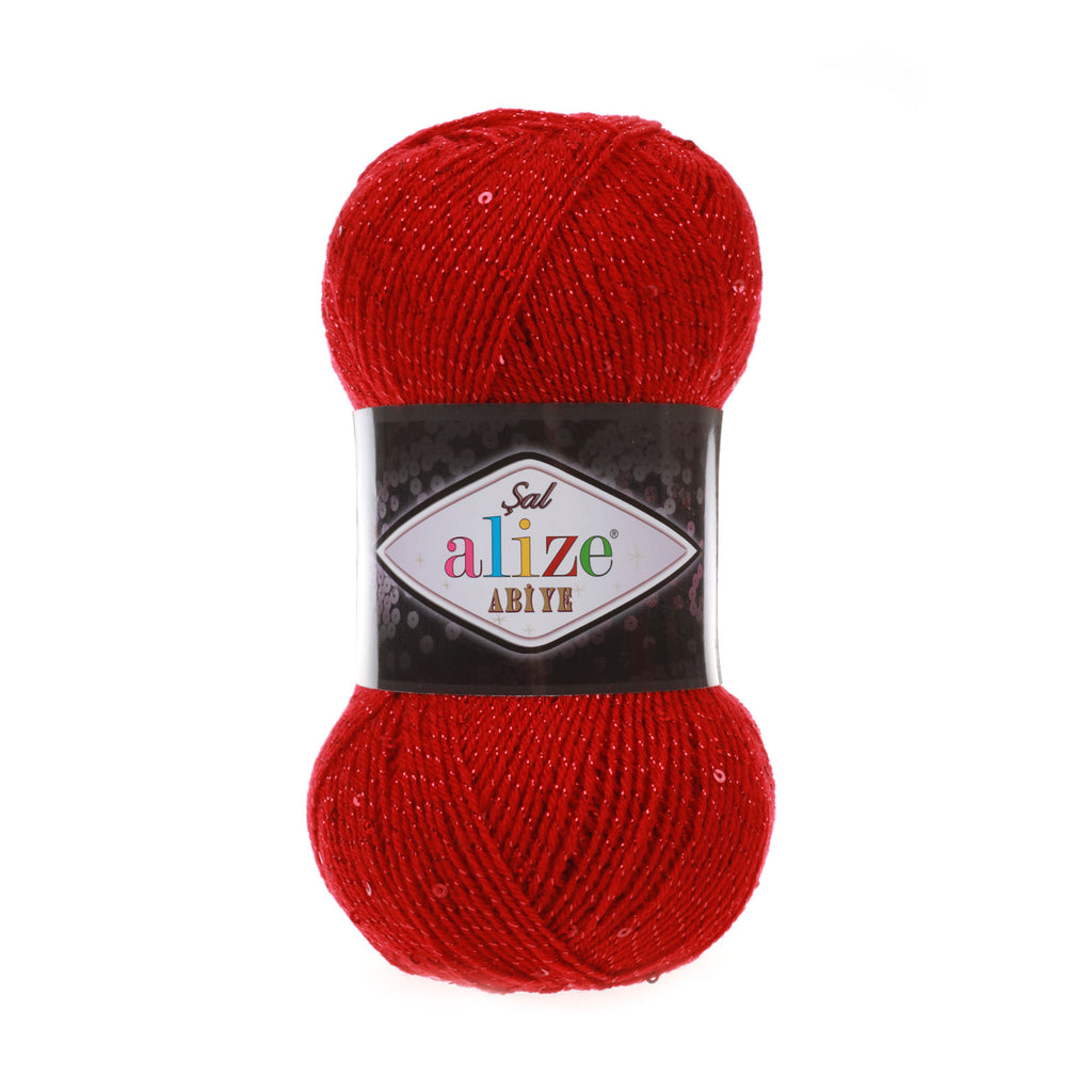 Zu sehen ist Alize Sal Abiye Wolle in einem kräftigen, glänzenden Rotton mit funkelnden Pailletten und Metallic‑Effekt; ein weiches, leicht schimmerndes Garn, ideal für Schals, Accessoires und elegante Handarbeitsprojekte.